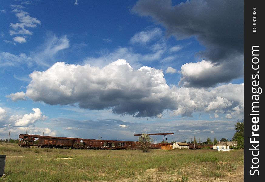 Railway under clouds in blue sky.
Ukraine.
May 2009.