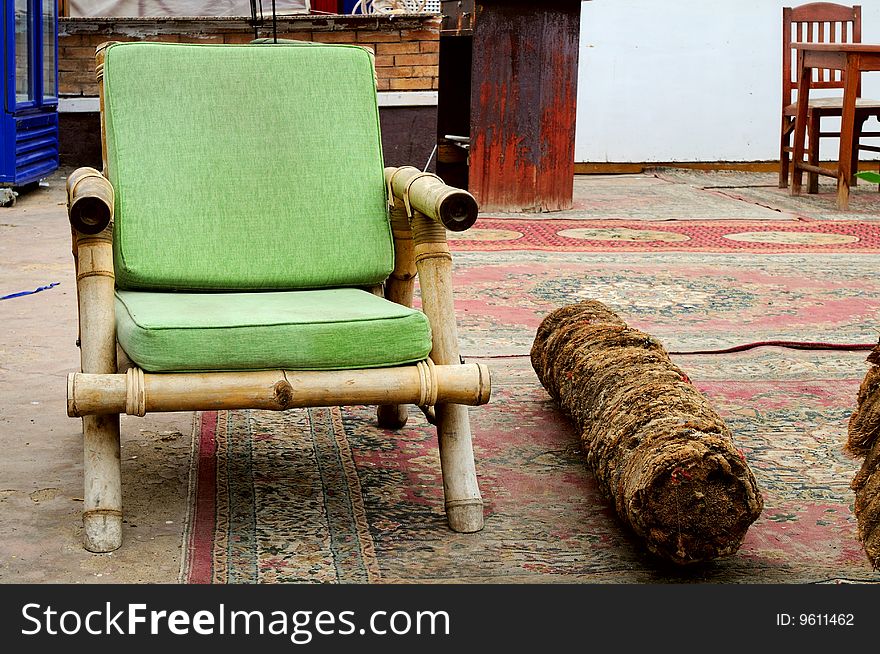 Old Green African armchair in exotic street cafe