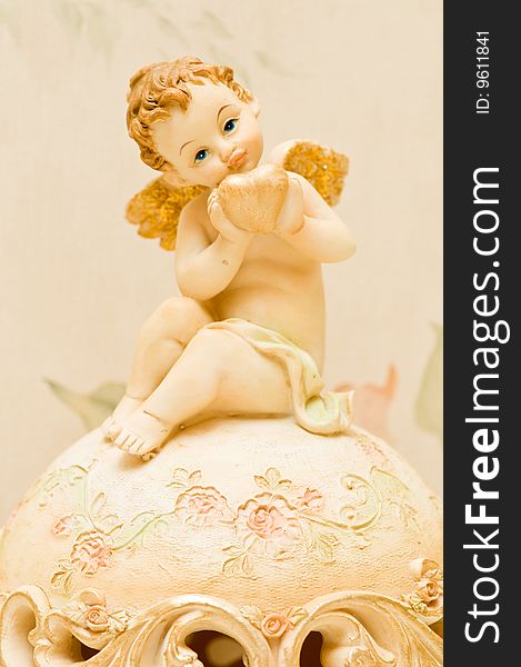 Cherub with heart and golden wings