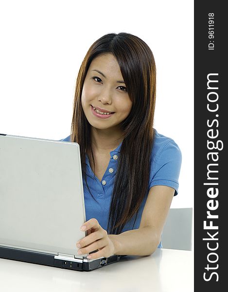 A pretty asian woman working on the laptop. A pretty asian woman working on the laptop