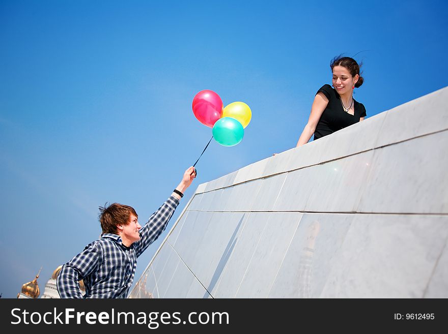 Young Girl And Boy Against Blue Sky