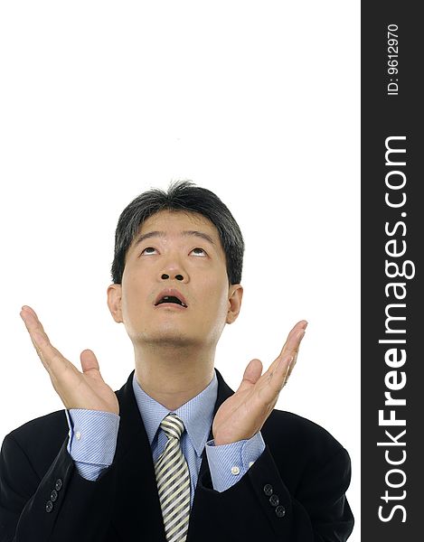 Stock photo of a surprised businessman looking up