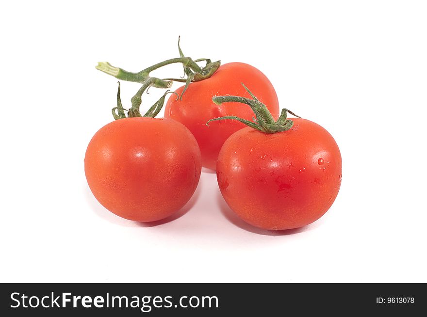 A small group of cherry tomatoes isolated against a white background