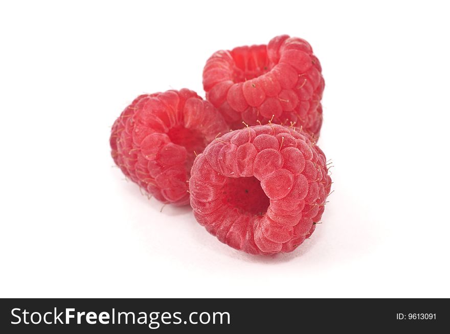 A group of raspberries isolated against a white background