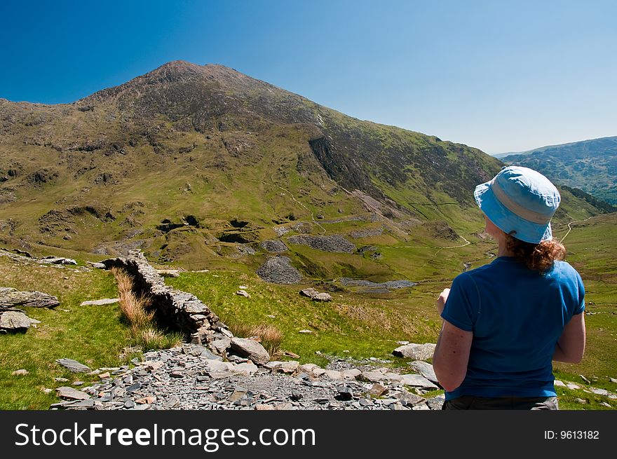 Woman looking up  at mountain in Snowdonia. Woman looking up  at mountain in Snowdonia