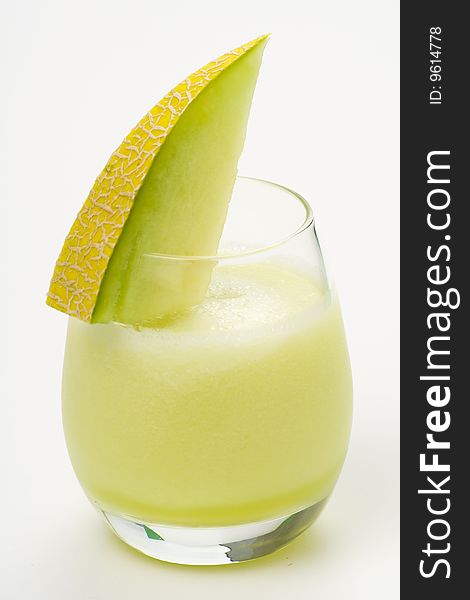 A delicious melon milkshake isolated over white. A delicious melon milkshake isolated over white