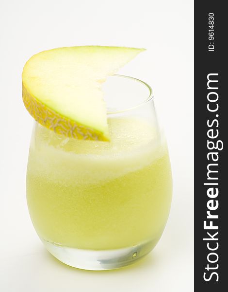 A delicious melon milkshake isolated over white. A delicious melon milkshake isolated over white