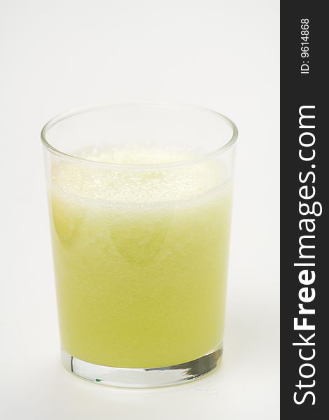 A delicious melon milkshake isolated over white. A delicious melon milkshake isolated over white