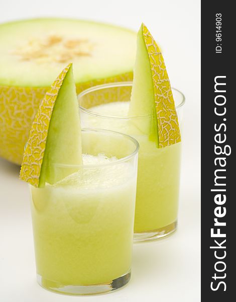 A delicious melon milkshake isolated over white. A delicious melon milkshake isolated over white