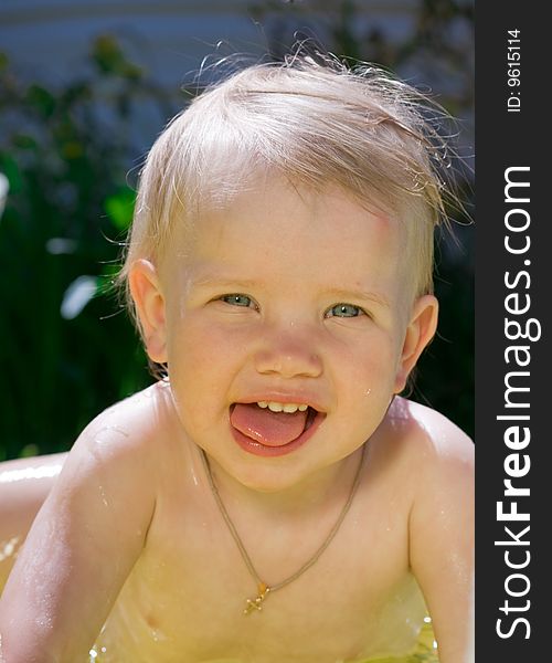 Happy little girl in yellow pool