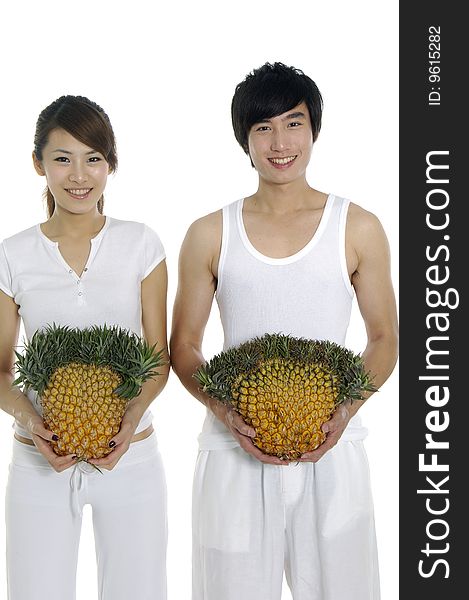 Happy couple showing a healthy fruit. Happy couple showing a healthy fruit