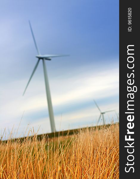 Modern windmill against the sky qutg grass close up