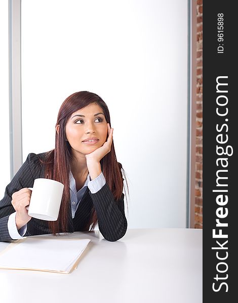 Business woman thinking in a modern office