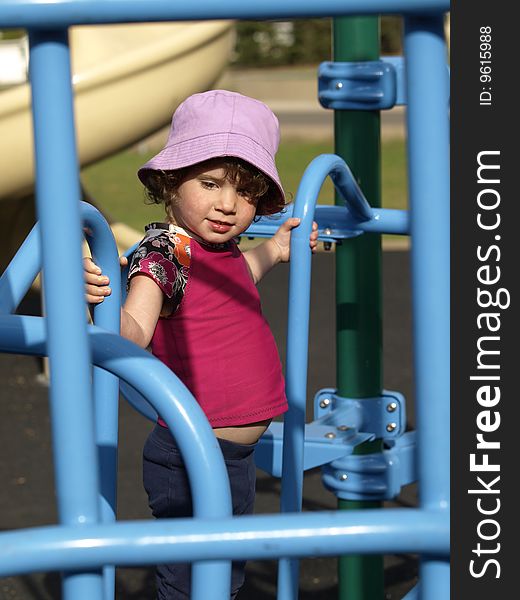This sweet young girl was having fun at the playground,working on her motor skills. This sweet young girl was having fun at the playground,working on her motor skills.