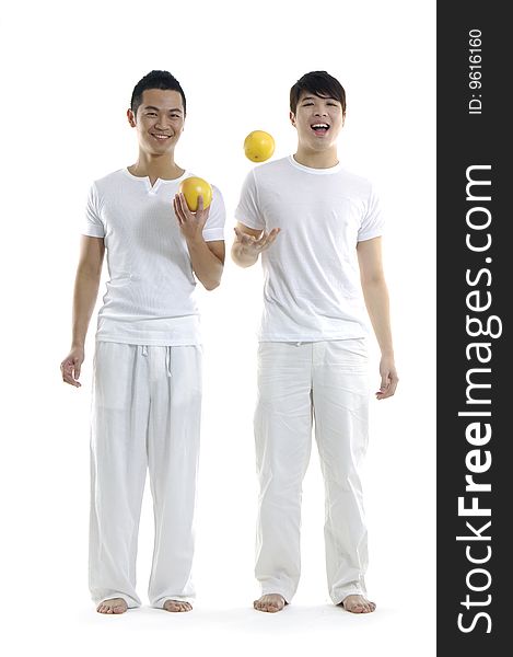 Young man holding and tossing grapefruit. Young man holding and tossing grapefruit
