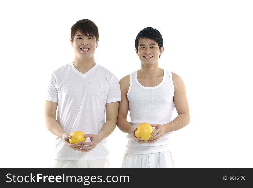 Young man holding and tossing grapefruit. Young man holding and tossing grapefruit