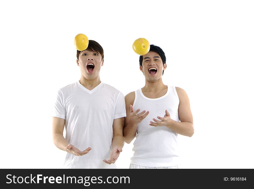 Couple young man tossing grapefruit. Couple young man tossing grapefruit
