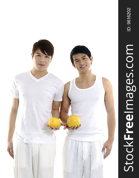 Asian couple young man holding grapefruit. Asian couple young man holding grapefruit