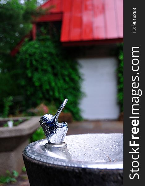 A drinking fountain covered with water drops