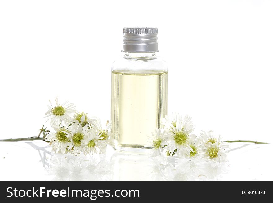 Spa bottles and daisies isolated on white. Spa bottles and daisies isolated on white