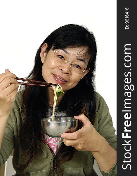 Young happy woman with plate of vermicelli at kitchen. Young happy woman with plate of vermicelli at kitchen