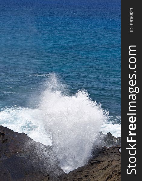 A blow hole in the pacific ocean in Hawaii