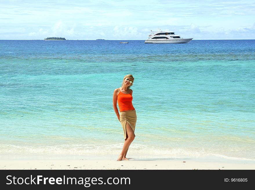 Beautiful happy girl on tropical island beach