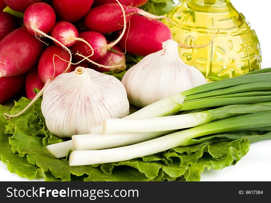 Green vegetables and a bottle of olive oil on the white background. Green vegetables and a bottle of olive oil on the white background