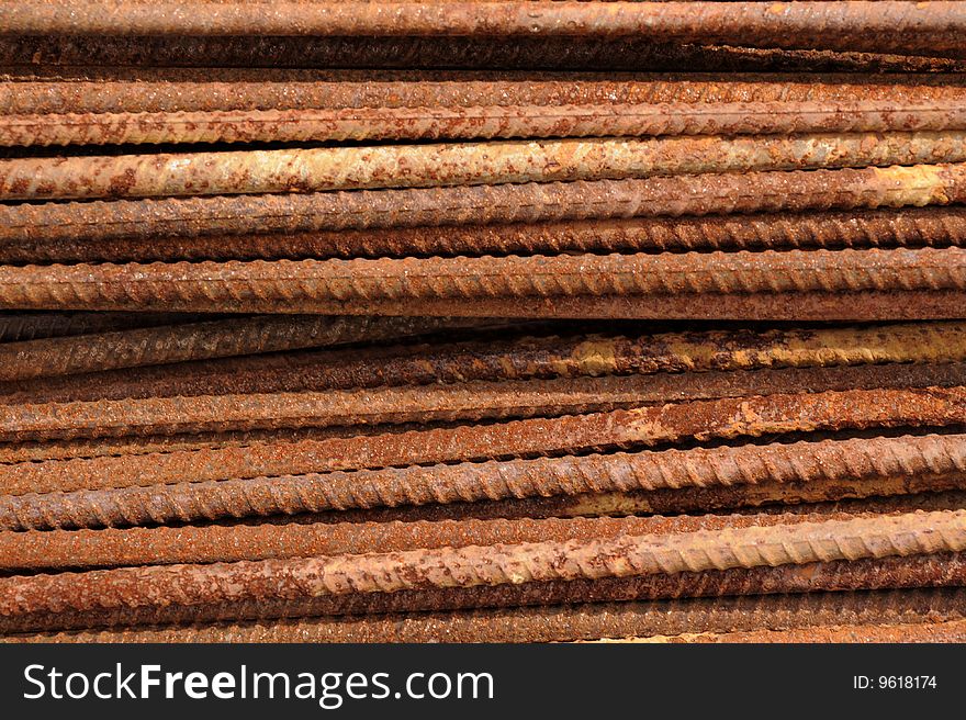 Rusted steel rods form a tough background.