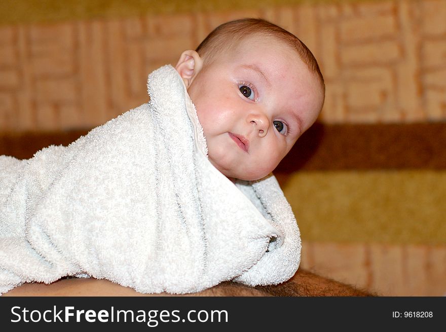 The kid wrapped in a towel after bathing. The kid wrapped in a towel after bathing