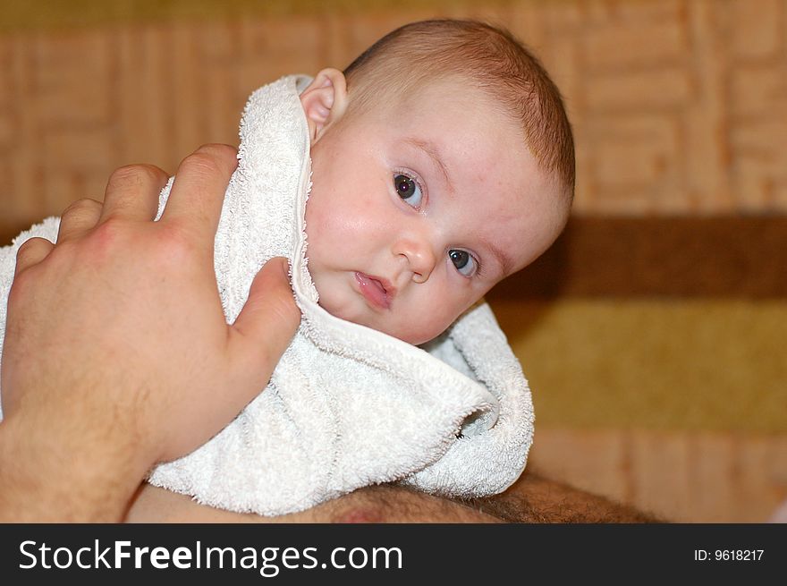 The kid wrapped in a towel after bathing. The kid wrapped in a towel after bathing