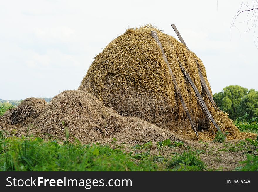 Bale of hay against the cloudy sky. Bale of hay against the cloudy sky