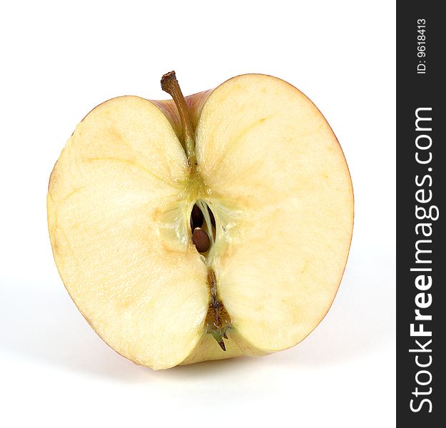 Apple cut in half on a white