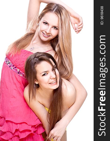 Two beautiful women in a colored dress on a white background isolated