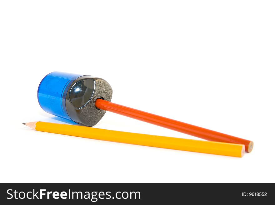 Orange and yellow pencils with sharpener on a white background. Orange and yellow pencils with sharpener on a white background