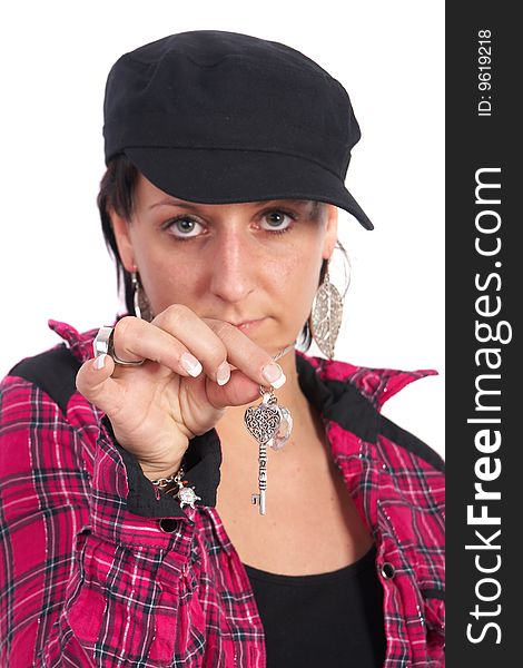 Portrait of a young woman wearing a pink shirt and ripped blue jeans. She is showing a key. Focus is on the key. Portrait of a young woman wearing a pink shirt and ripped blue jeans. She is showing a key. Focus is on the key.