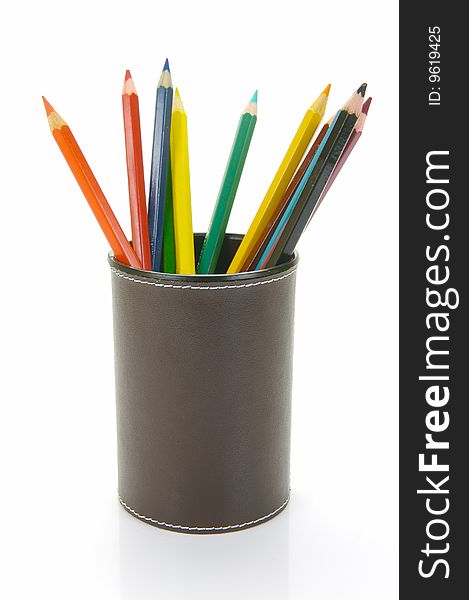 Colored Pencils in a cup holder isolated against a white background. Colored Pencils in a cup holder isolated against a white background