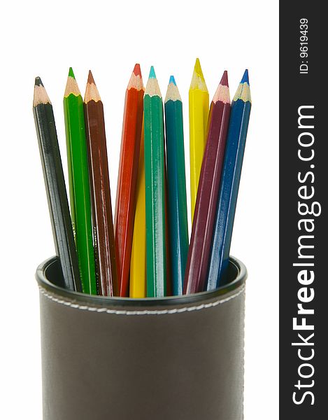 Colored Pencils in a cup holder isolated against a white background. Colored Pencils in a cup holder isolated against a white background