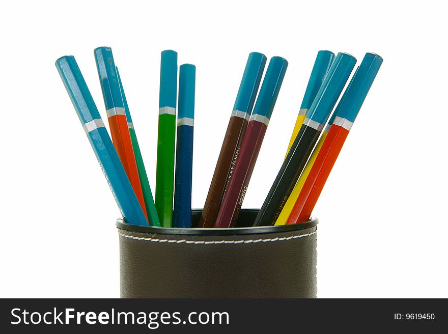 Colored Pencils in a cup holder isolated against a white background. Colored Pencils in a cup holder isolated against a white background