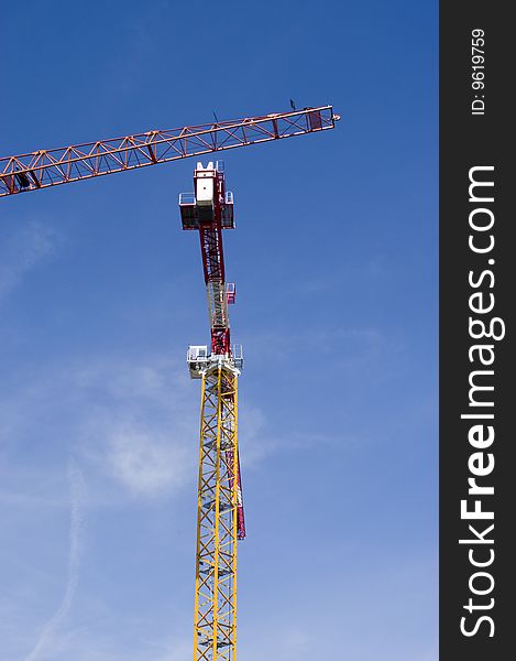 Two construction cranes on a blue sky