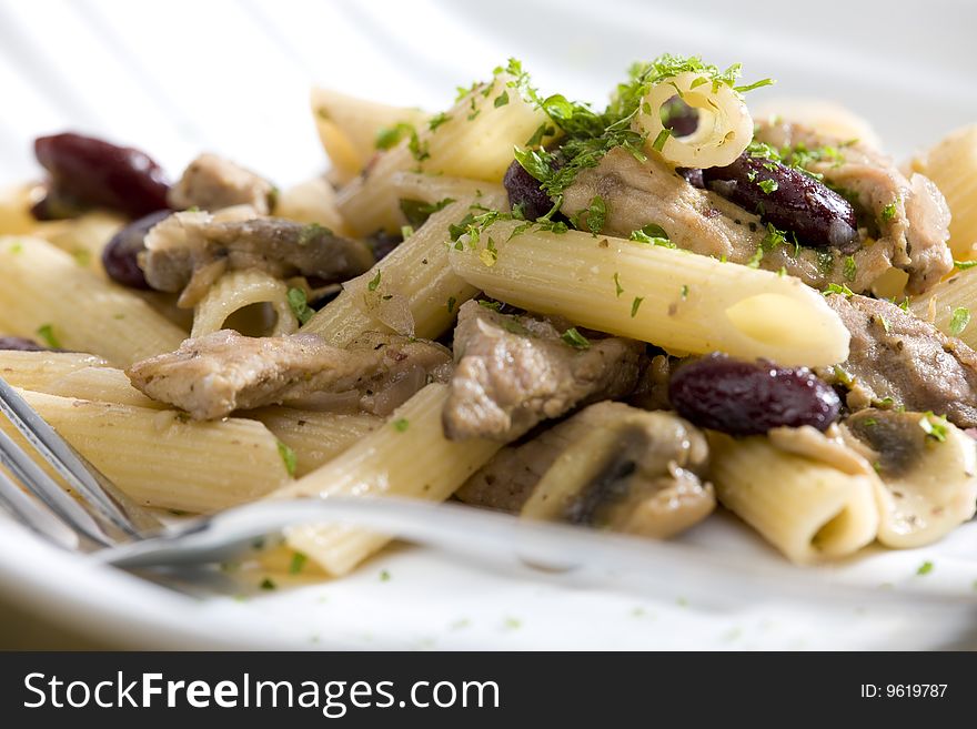 Penne with pork pieces and champignons. Penne with pork pieces and champignons