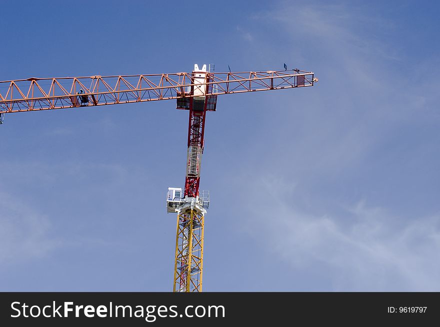 Two construction cranes on a blue sky