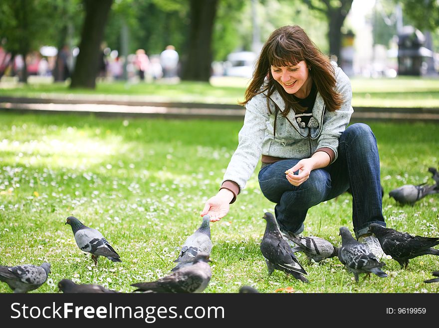 Happy Woman With Doves In Park