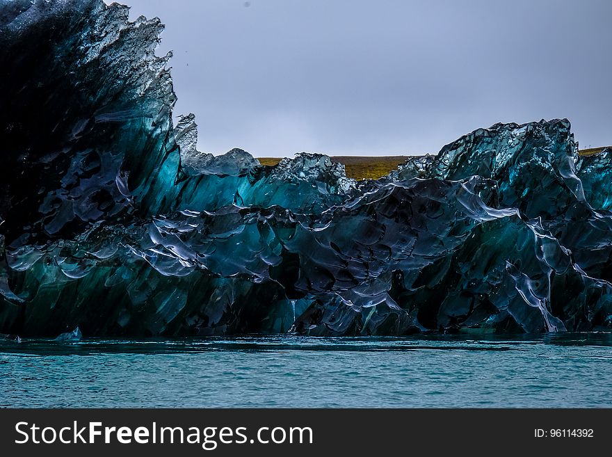 A blue sea ice formation on the coast.
