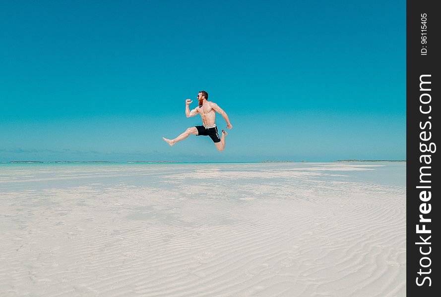 Full Length of a Man Jumping from Beach