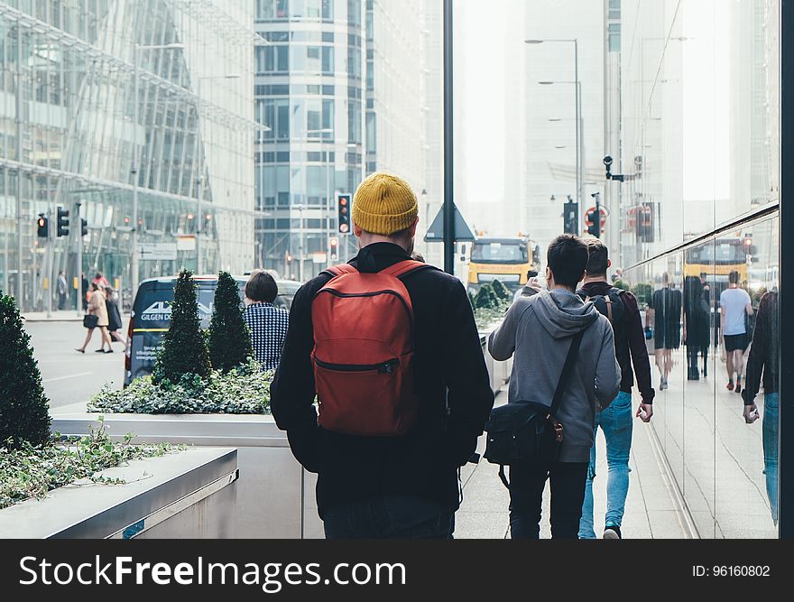 Man In Black Jacket And Carrying Red Backpack