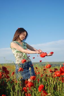 Girl On A Red Poppies Field Stock Photo