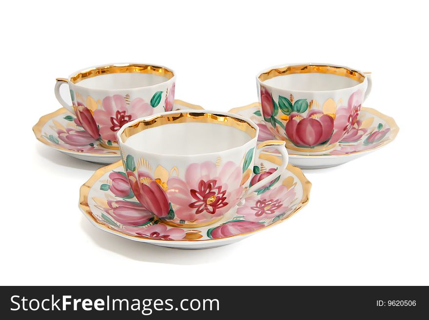 Three tea cups with saucers isolated
