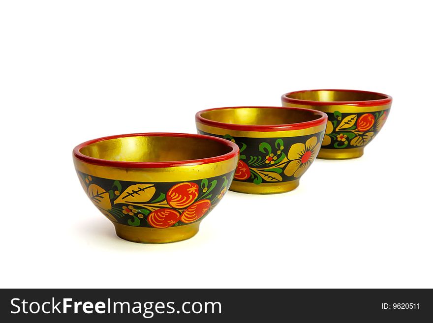 Three painted Russian wooden khokhloma cups  isolated. Three painted Russian wooden khokhloma cups  isolated