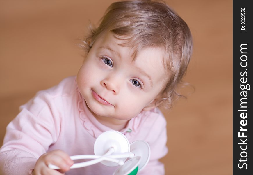 Little girl playing with rattle - shallow DOF